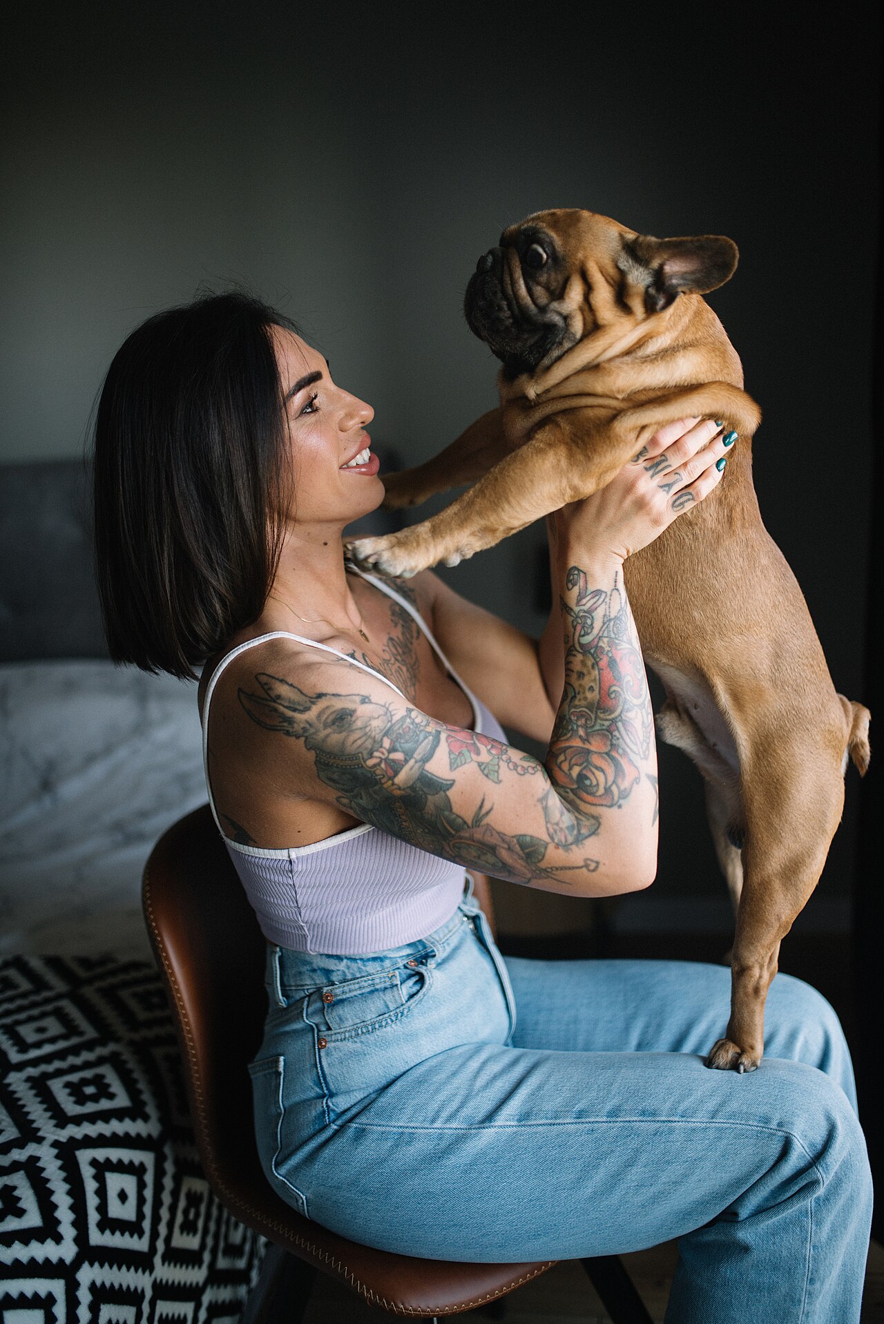 Woman smiling with her French bulldog